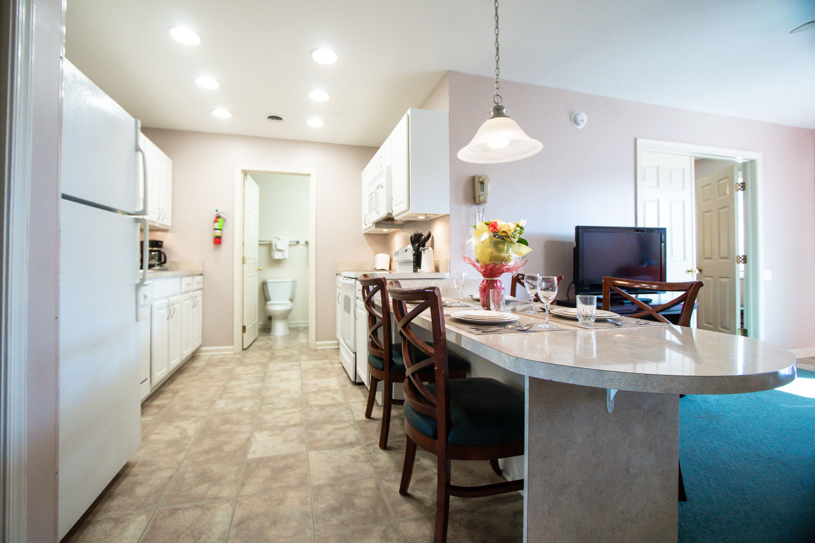 A fully equipped dining and kitchen at VRI's Club Ocean Villas II in Ocean City, Maryland.